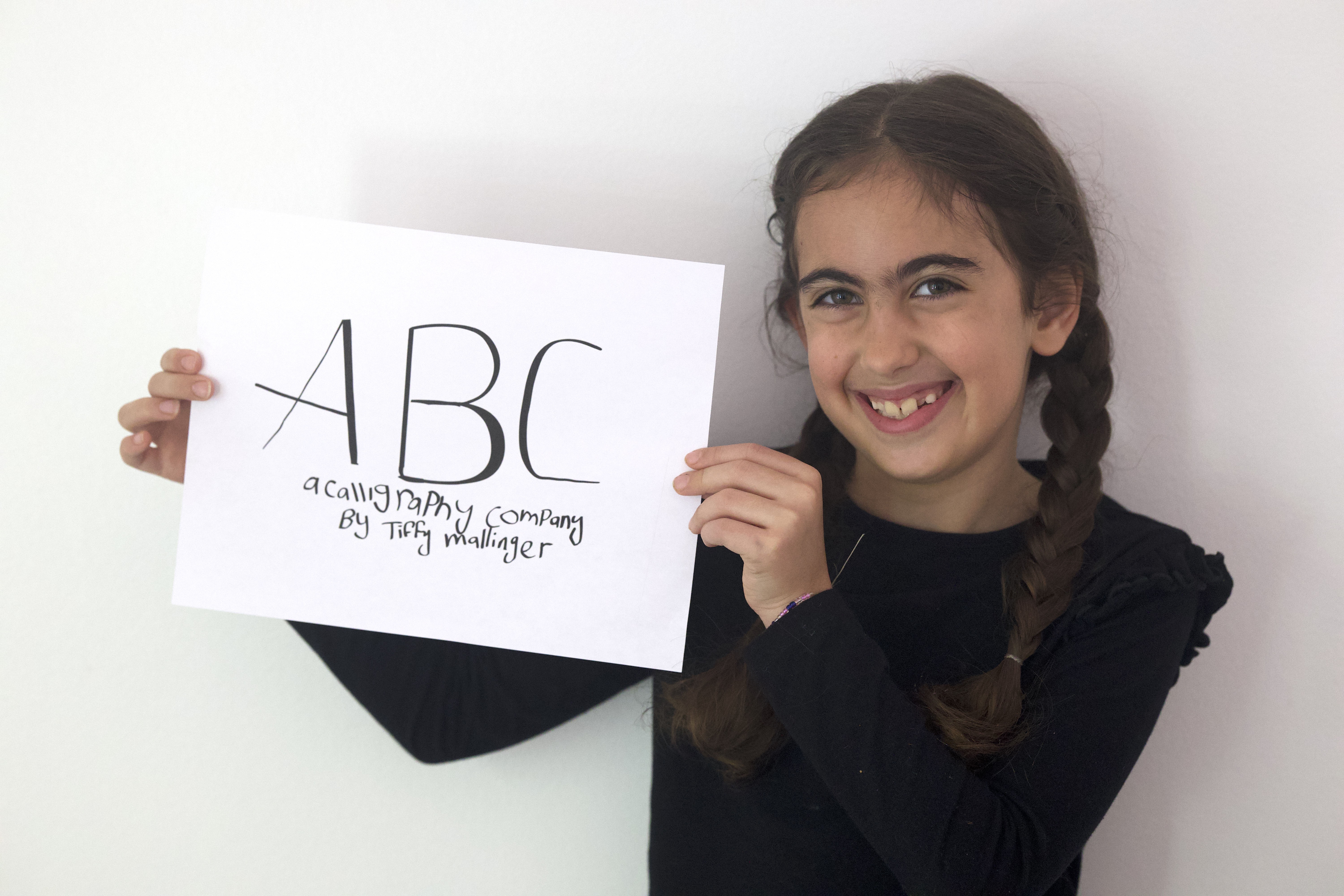 Tiffy Mallinger holding her ABC Calligraphy logo